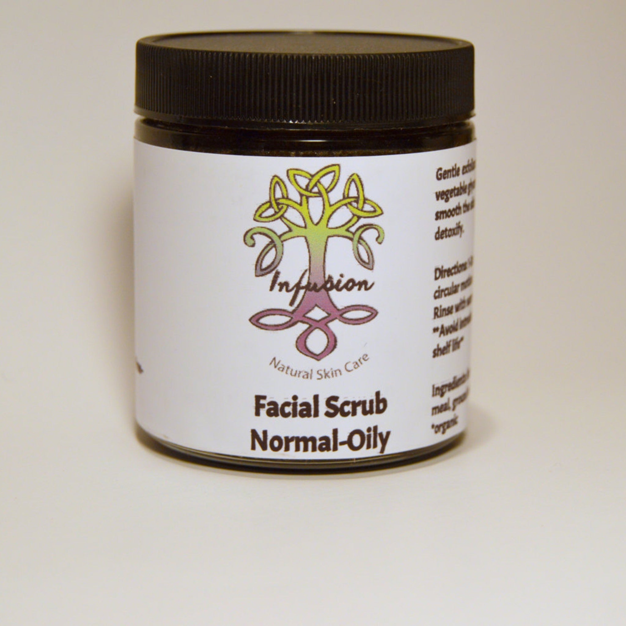 Facial scrub jar with black lid and white label, Infusion Natural Skin Care product