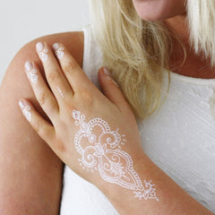Minimalist white henna tattoo kit with natural designs, safe for sensitive skin, in sleek eco-friendly packaging