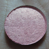 Petal Soft Eye Shadow in a round compact with smooth matte pink casing and shimmering neutral-toned powder.