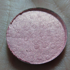 Petal Soft Eye Shadow in a round compact with smooth matte pink casing and shimmering neutral-toned powder.