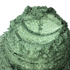 Sage green eyeshadow with silver glitter and textured surface, close up view