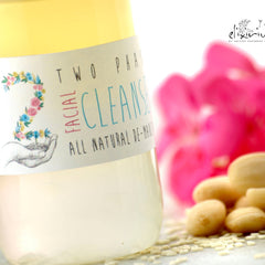 Facial cleanser bottle with floral label, clear liquid, and "elixirium" branding
