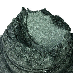 Powder pigment, dark green, glittery, textured surface, close-up view