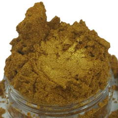 Gold powder with glitter, in a clear jar, with a granular texture.