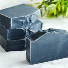 Charcoal facial soap bars, dark gray rectangular, stacked with rough edges