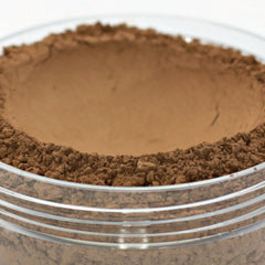 Vegan mineral powder foundation, dark brown powder, clear jar, layered texture
