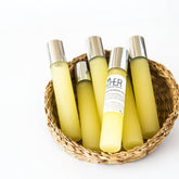 Eye makeup roll-on bottles, yellow glass, silver cap, in woven basket, EstherSkincare label