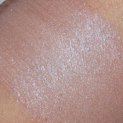Close-up of peach tan eyeshadow with vibrant blue shimmer particles, showcasing vegan mineral makeup texture