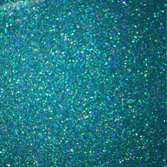 Side view of vibrant turquoise loose glitter in a clear jar with silver screw-top lid, showcasing fine shimmer particles.
