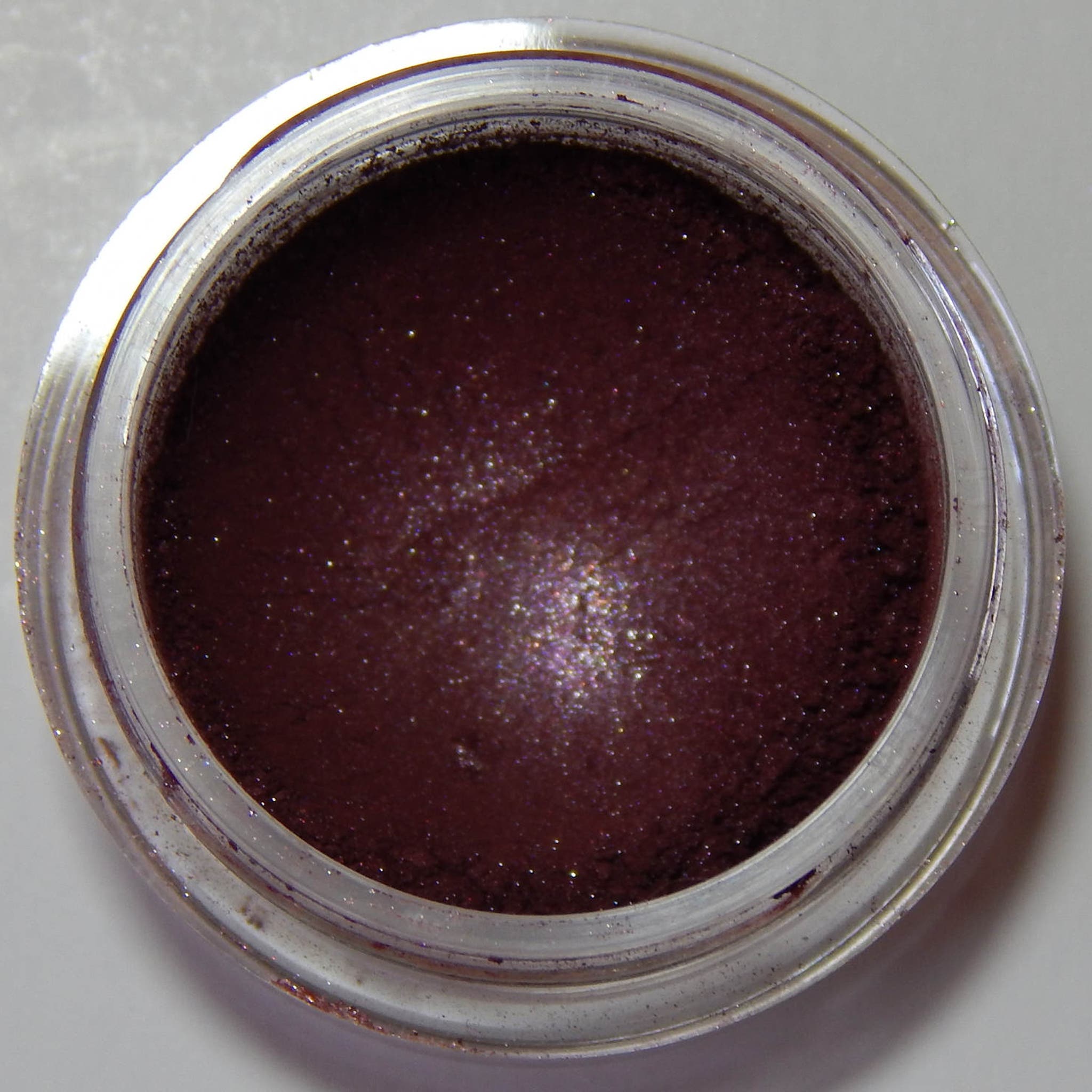 Single Escapade Eye Shadow compact in matte taupe shade with sleek black case and mirrored interior.