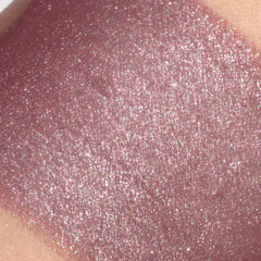 Close-up of burgundy red shimmer vegan eyeshadow with sparkling mineral particles in compact pan