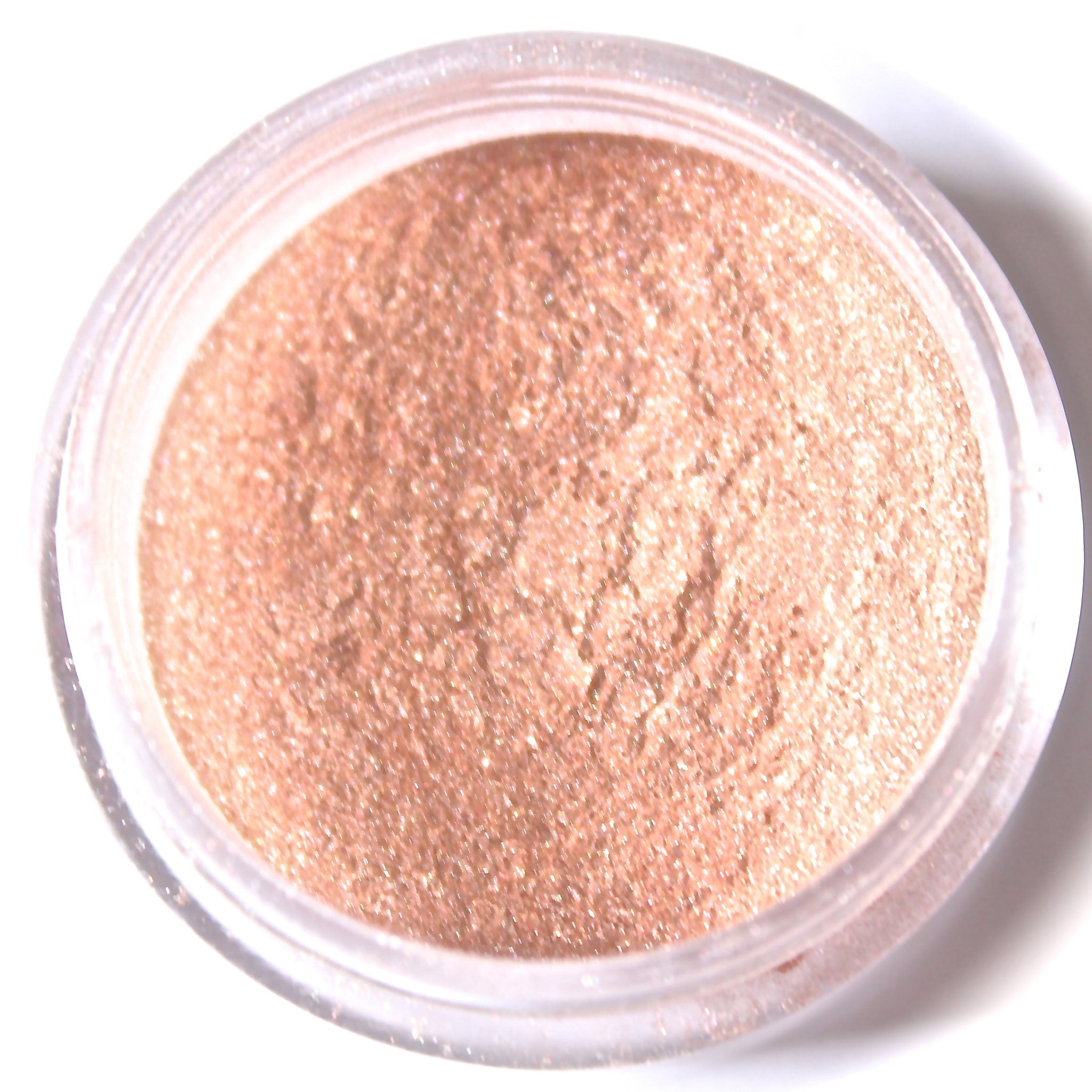 Eyeshadow powder rose gold shimmer loose powder in clear plastic container