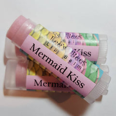 Lip balm tubes with pink balm, clear plastic casing, and Lee's Bees label