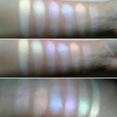 Eyeshadow swatches, iridescent rainbow shades on arm, various colors and textures