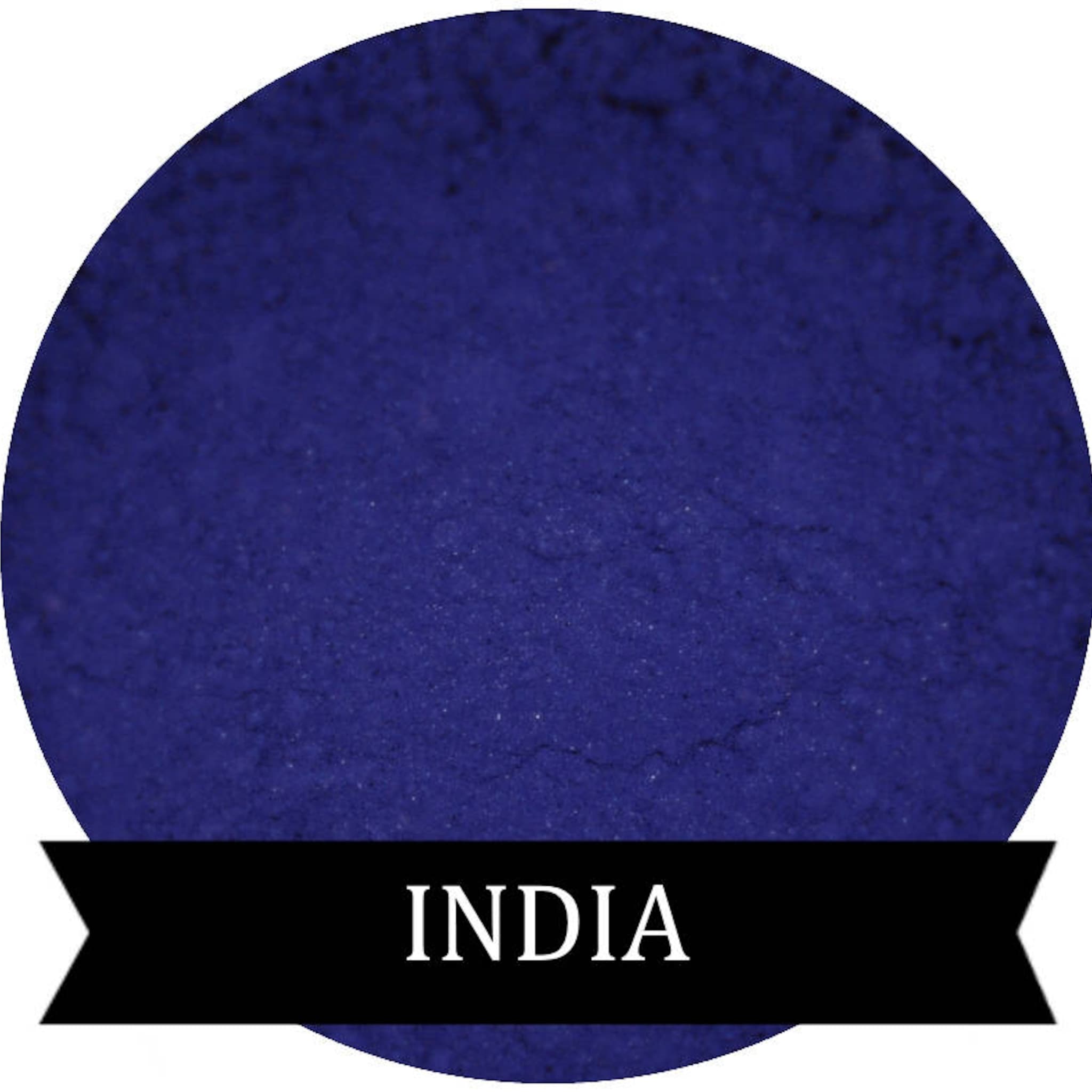 Matte eyeshadow powder in indigo color, circular shape with "INDIA" text on black banner
