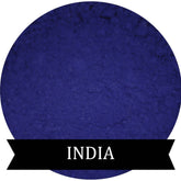 Matte eyeshadow powder in indigo color, circular shape with "INDIA" text on black banner