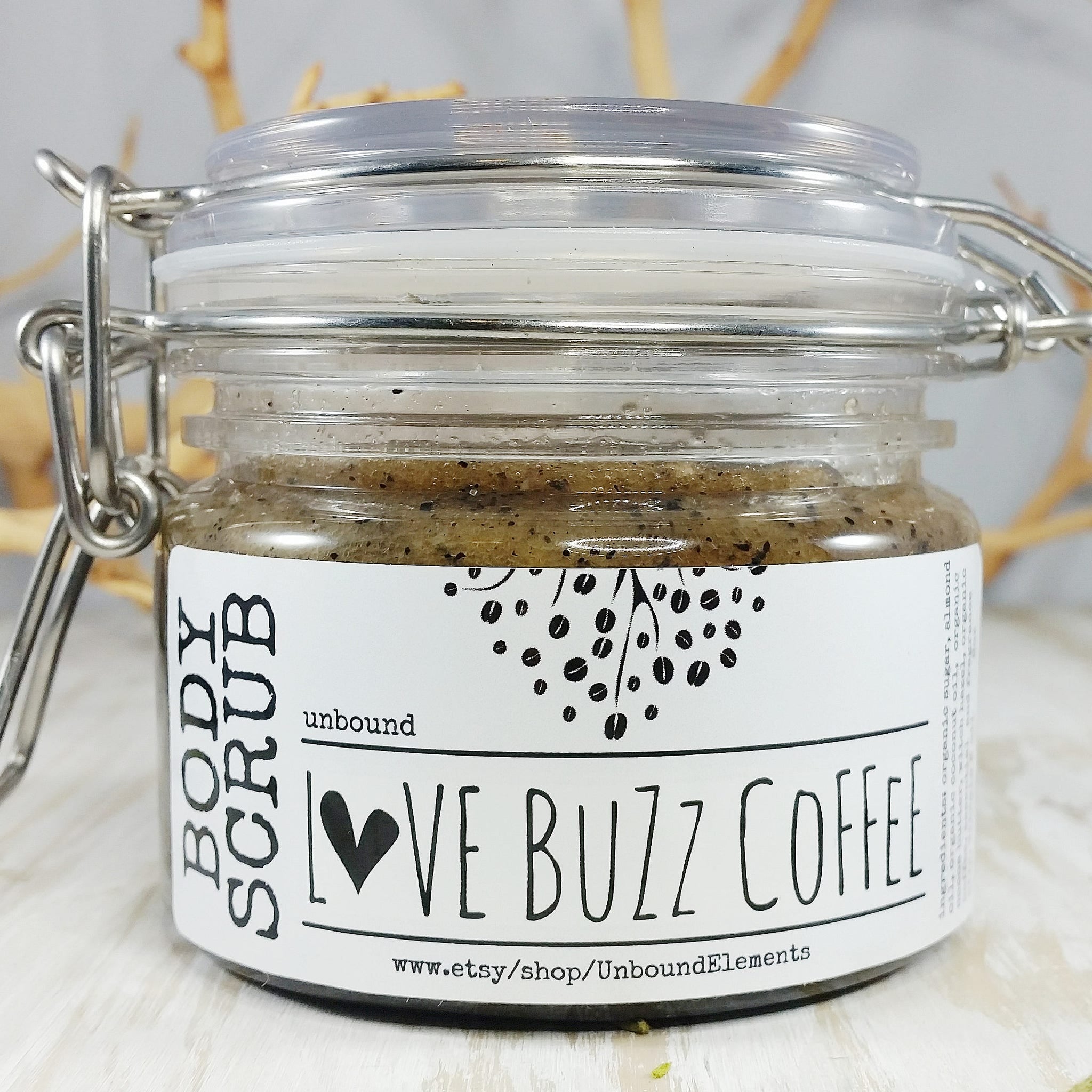 Body scrub in glass jar with metal clasp and "Love Buzz Coffee" label