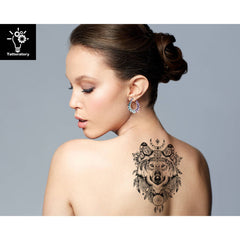 Elegant sheet of wolf & feather temporary tattoos with gold detailing, displayed on clean skincare vanity