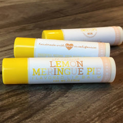 Lip balm tubes with yellow caps, white labels, and text Lemon Meringue Pie flavor