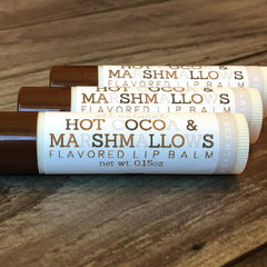 Lip balm tubes with brown caps, white labels, and "Hot Cocoa & Marshmallows" text on them