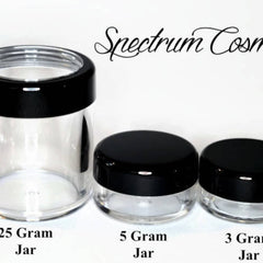 Cosmetic jars with black lids, clear glass, and Spectrum Cosmetics text
