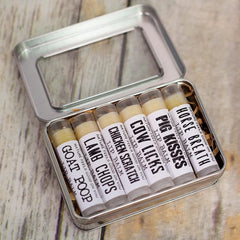 Lip balms in a metal tin, with white labels, clear tubes, and tan balm inside.
