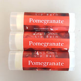 Lip balm tubes with red and white labels, Lee's Bees brand, showing Pomegranate text