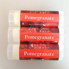 Lip balm tubes with red and white labels, Lee's Bees brand, showing Pomegranate text