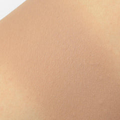 Skin texture with light peach color and fine lines visible on the surface