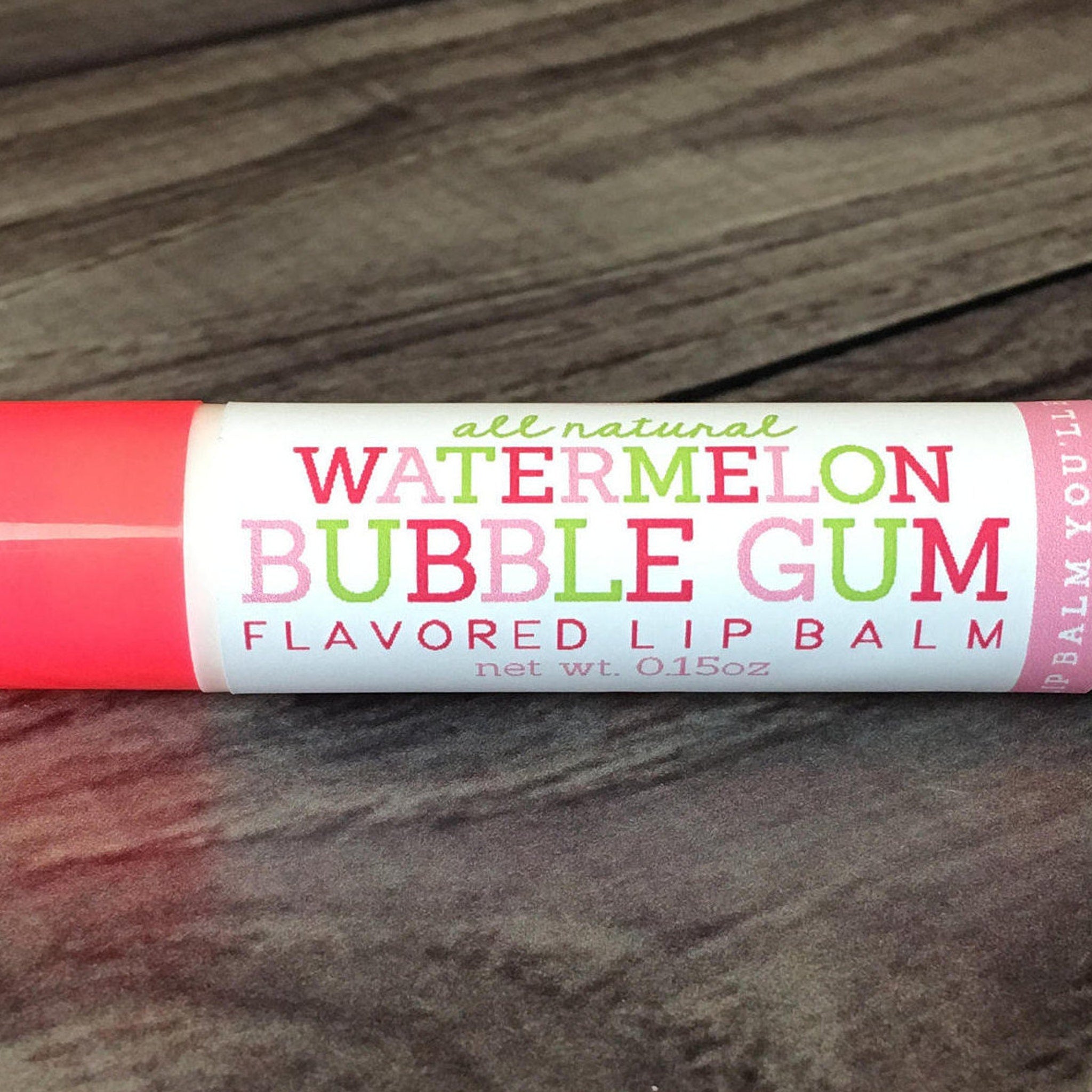 Watermelon Bubble Gum Lip Balm with pink and green text on white tube, SweetLipsLBCo brand