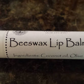 Beeswax Lip Balm tube with white label, black text, and dotted border