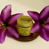 Clay face mask jar with gold lid and purple flowers, Nana's Naturals branding visible