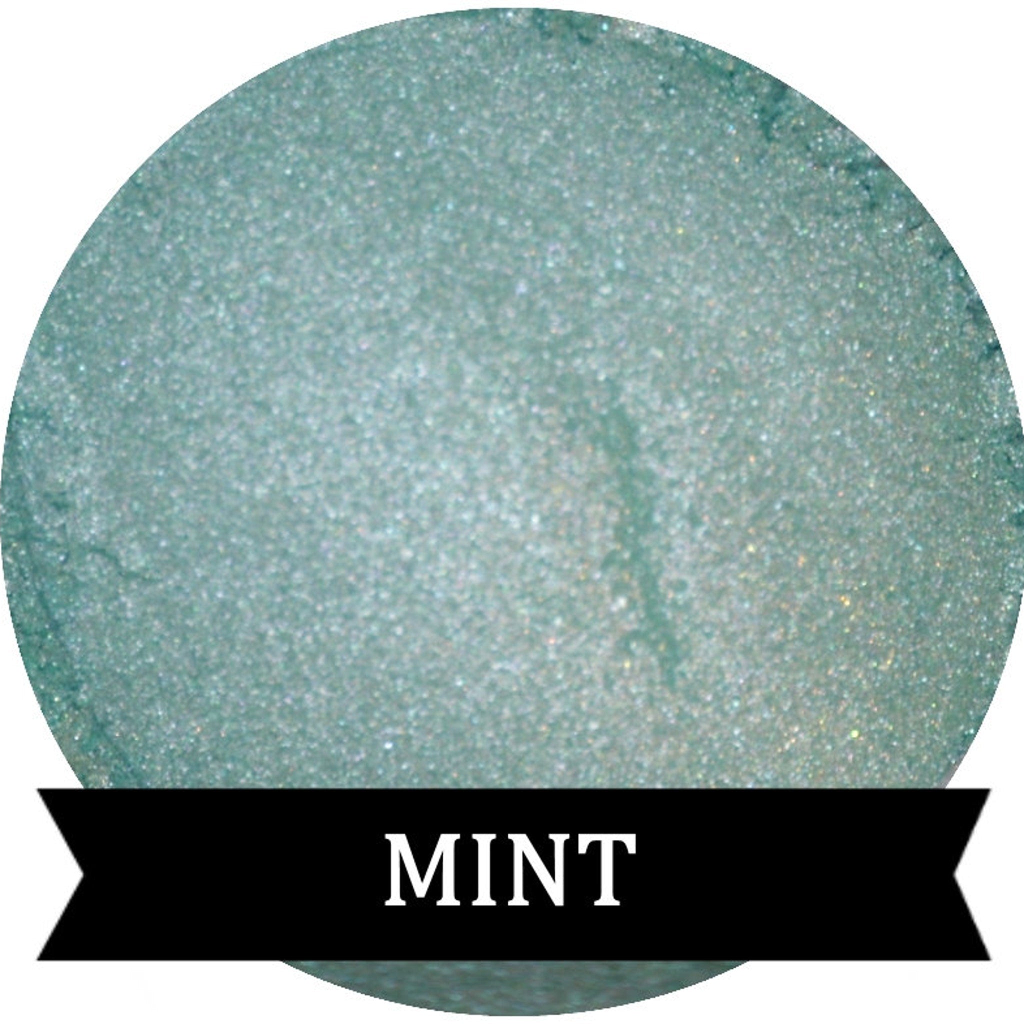 Single pan of mint green eyeshadow with soft matte finish in sleek black compact
