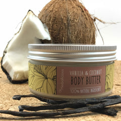 Close-up of rich vanilla coconut body butter in a white jar with gold lid, showing creamy texture and organic ingredients.