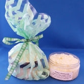 Lemon lime sugar scrub in clear jar with white granules, green chevron bag, and plaid ribbon