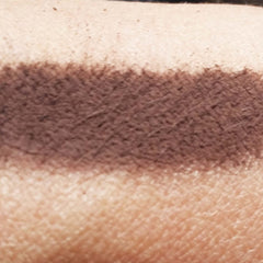 Close-up of matte deep chocolate brown loose mineral eye shadow with fine powder texture
