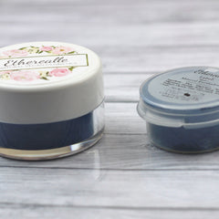 Eyeshadow jars, white and blue, with Etherealle text, floral lid, and matte finish