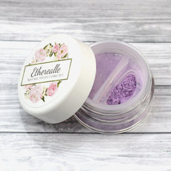 Etherealle Natural Vegan Cosmetics powder, purple, clear jar, white lid with floral design