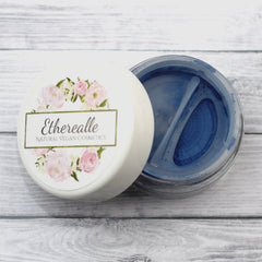 Cosmetic powder in blue, white jar with floral design, Etherealle brand visible
