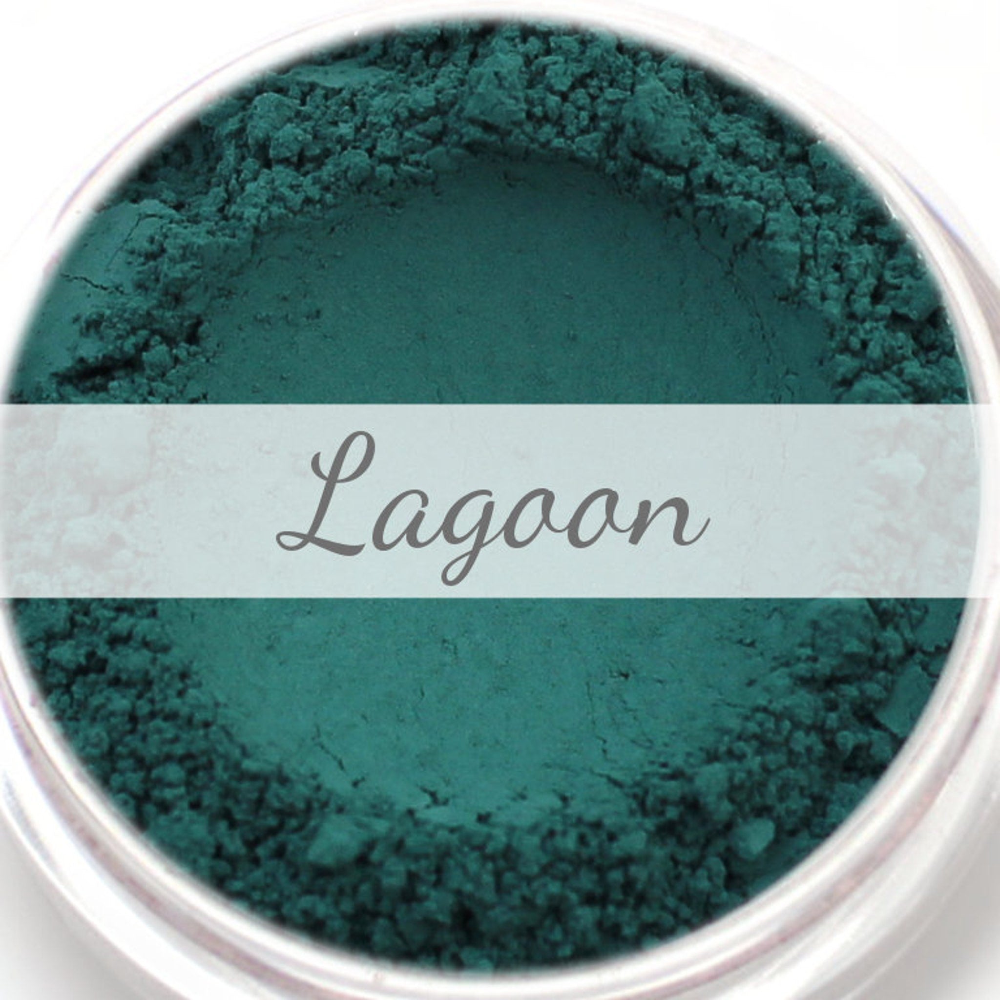 Matte teal eyeshadow sample with "Lagoon" text, teal powder in a jar