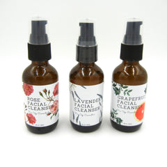 Facial cleanser bottles with brown glass, black pump tops, and floral labels from Pin Up Cosmetics