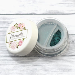 Eyeliner powder in teal green, clear plastic container, floral label with Etherealle text