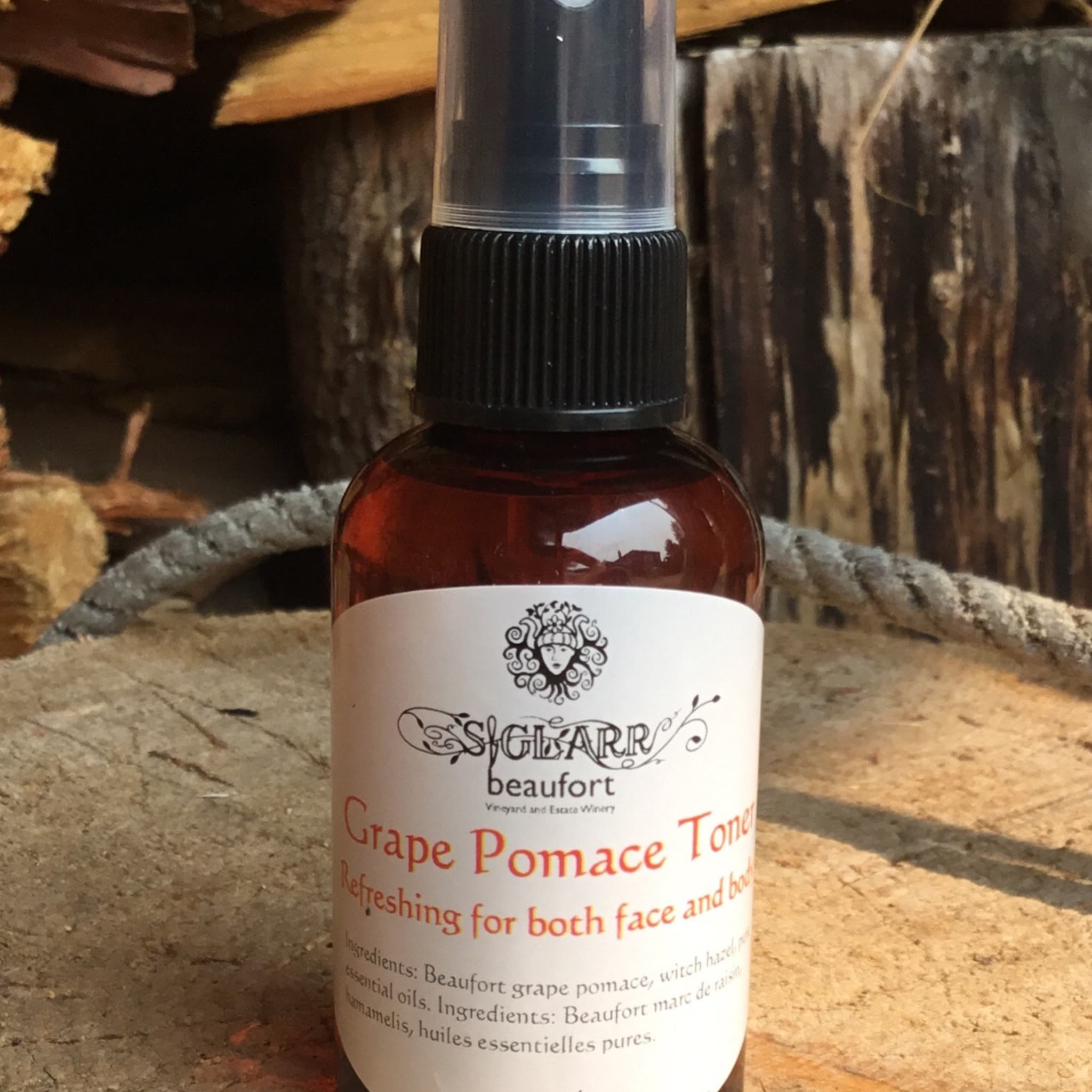 Face toner bottle with brown liquid, black cap, and white label with Siglarr text