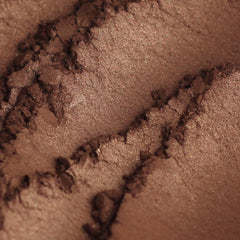 Side view of Legend Bronze Brown mineral eyeshadow sample showing rich matte texture in compact