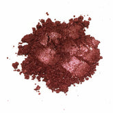 Loose eyeshadow, reddish-brown glittery powder, close-up view on white background