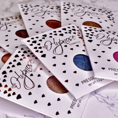 Pressed eyeshadow palettes with white packaging, black accents, and "Hypnose" text