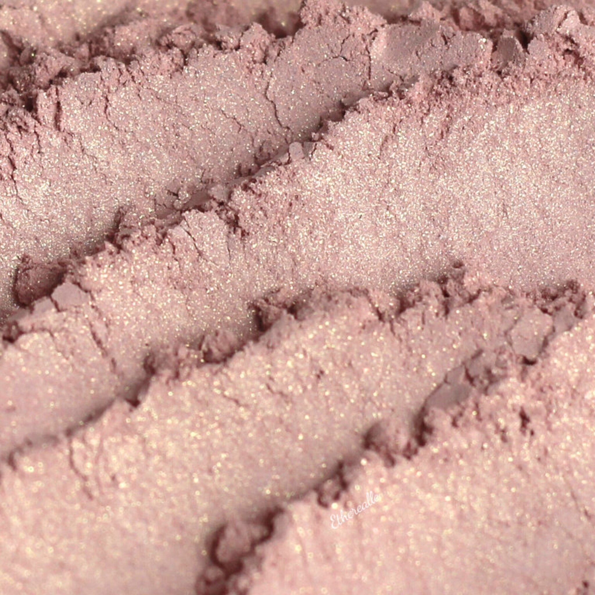 Eyeshadow powder in light pink with gold shimmer, Heiress brand visible
