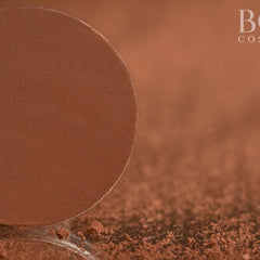 Brown powder eyeshadow with textured surface, and brand name "B" in white text