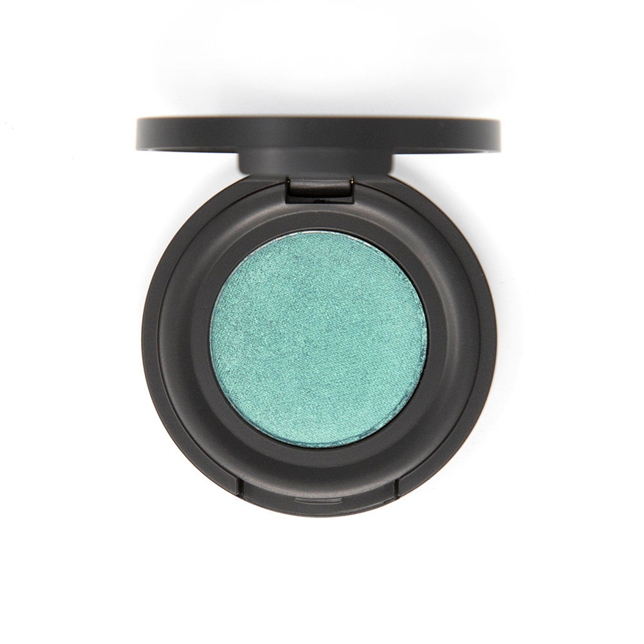 Vibrant mermaid green eyeshadow pan with shimmer finish in sleek black compact packaging