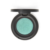 Vibrant mermaid green eyeshadow pan with shimmer finish in sleek black compact packaging